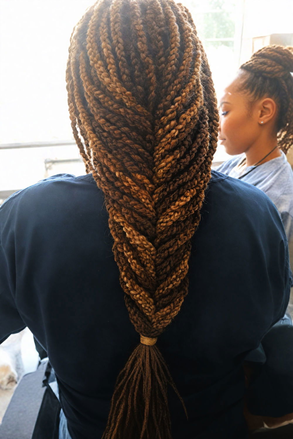 intricate and sophisticated fishtail braid with box braids