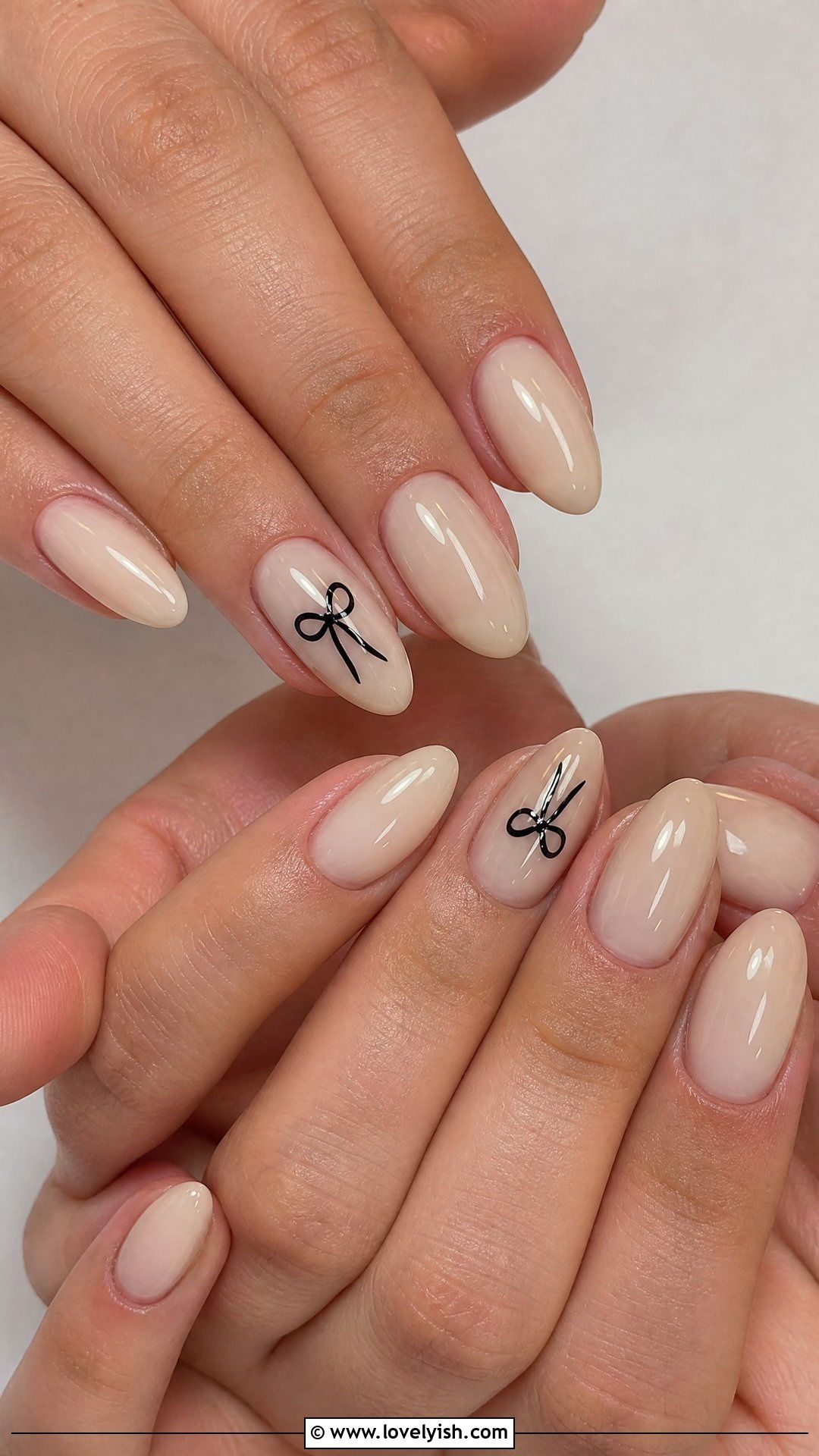 Glossy Nude With Tiny Bow - 42 easy nail art ideas - 42 easy nail art ideas